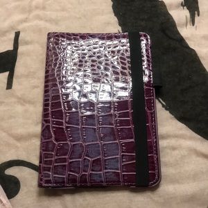 Purple iPad mini case with rotating screen and elastic strap.